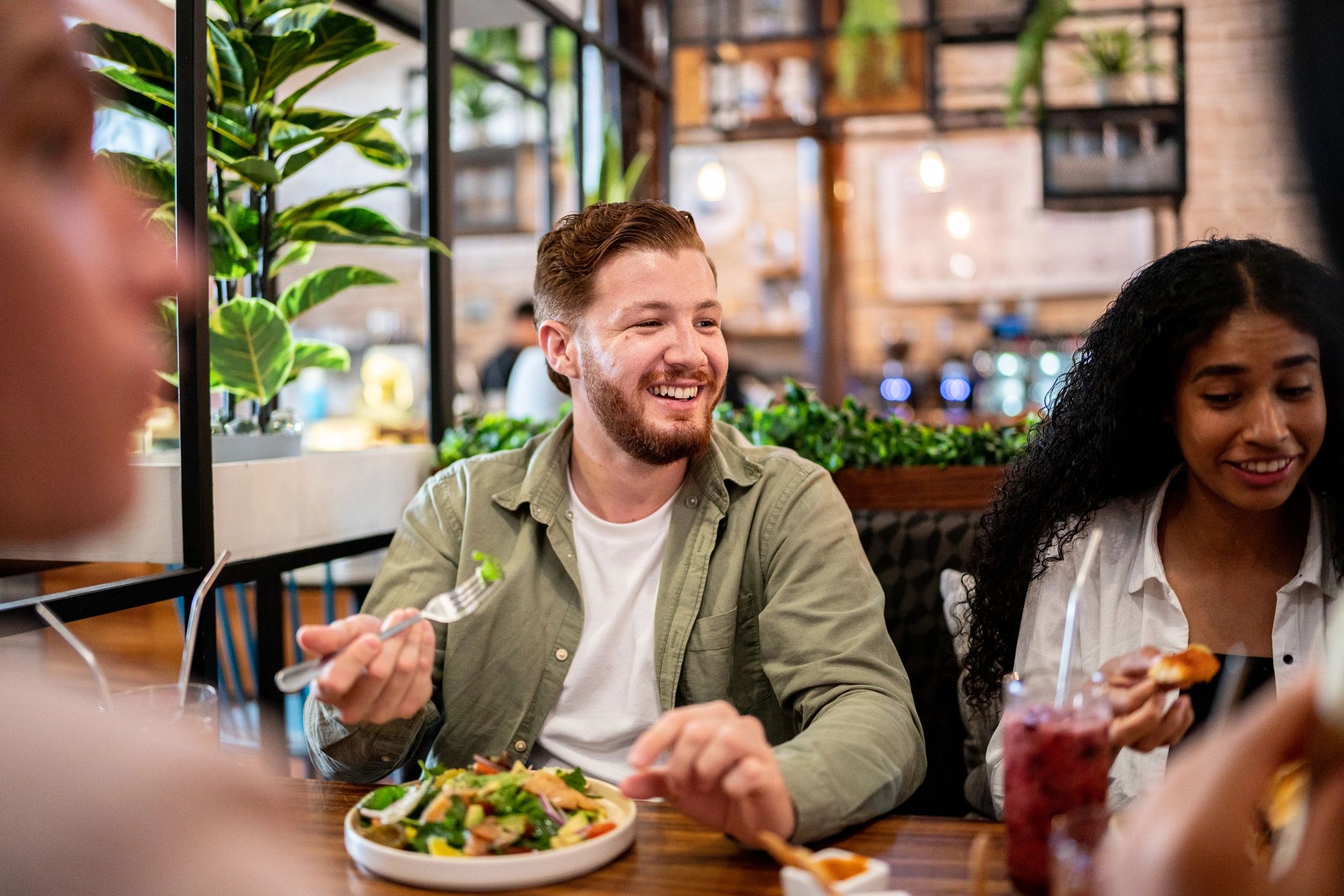 Friends enjoying a meal together at a restaurant table