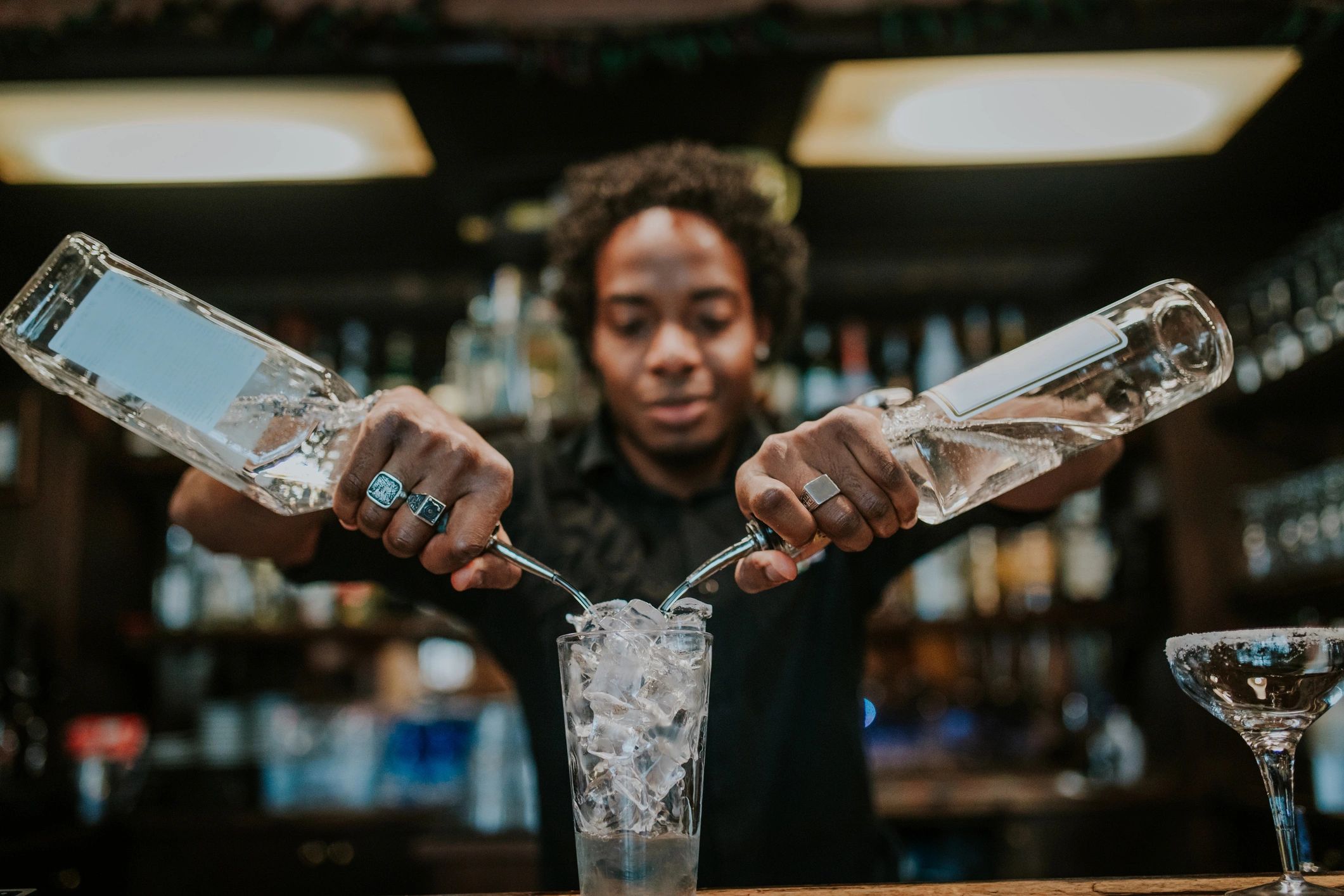 Bartender pouring a cocktail at the bar